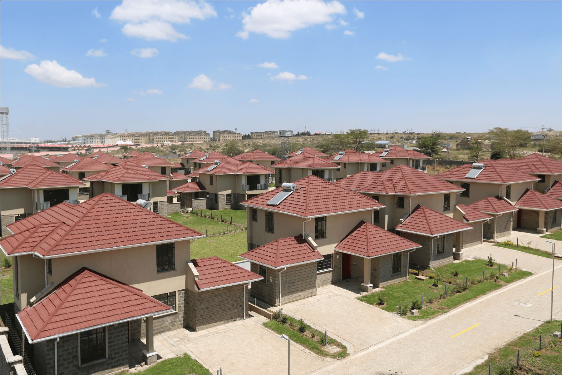 Aerial view of a housing estate with red metal roofs